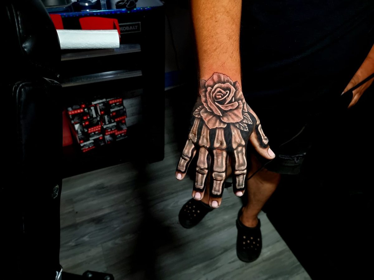 Skeleton hand and rose